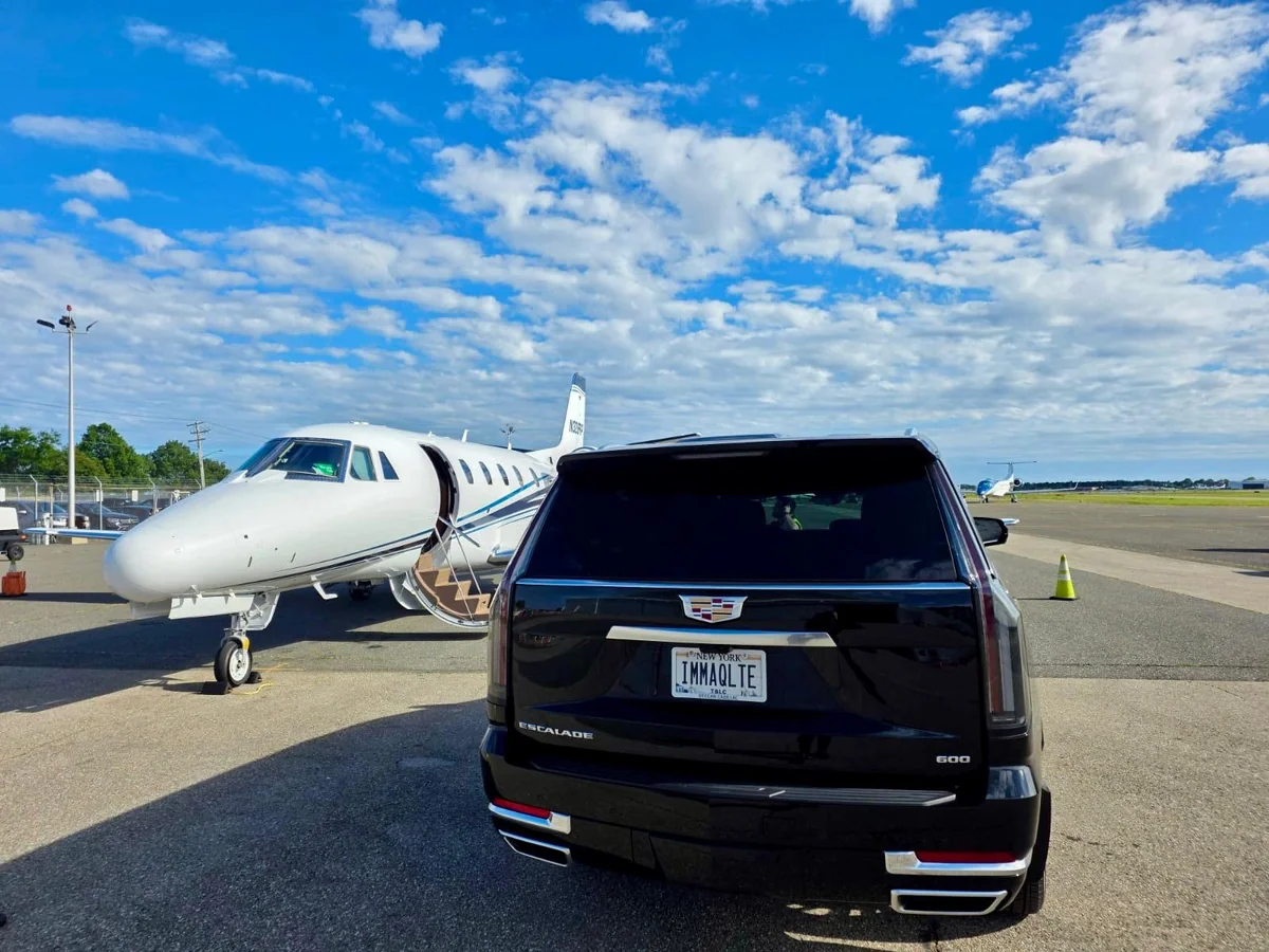 Rear view of a black Cadillac Escalade at an airport