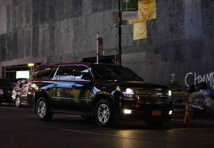 Black SUV on a city street at night
